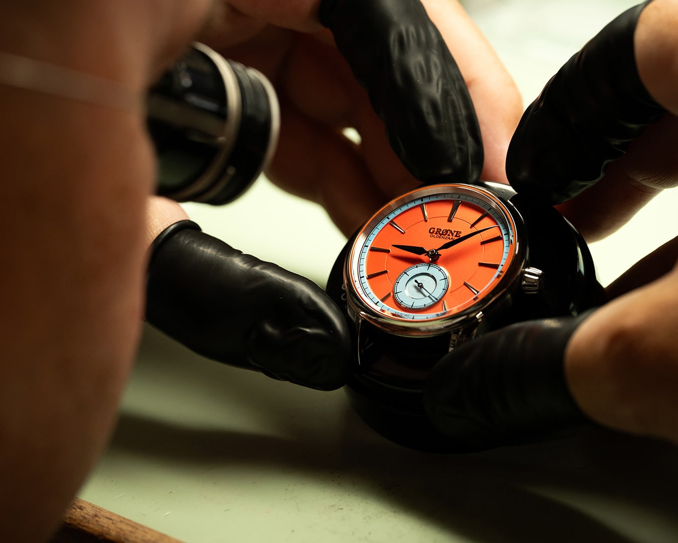 GRØNE Horologium Something Quirky being handled in a workshop setting.